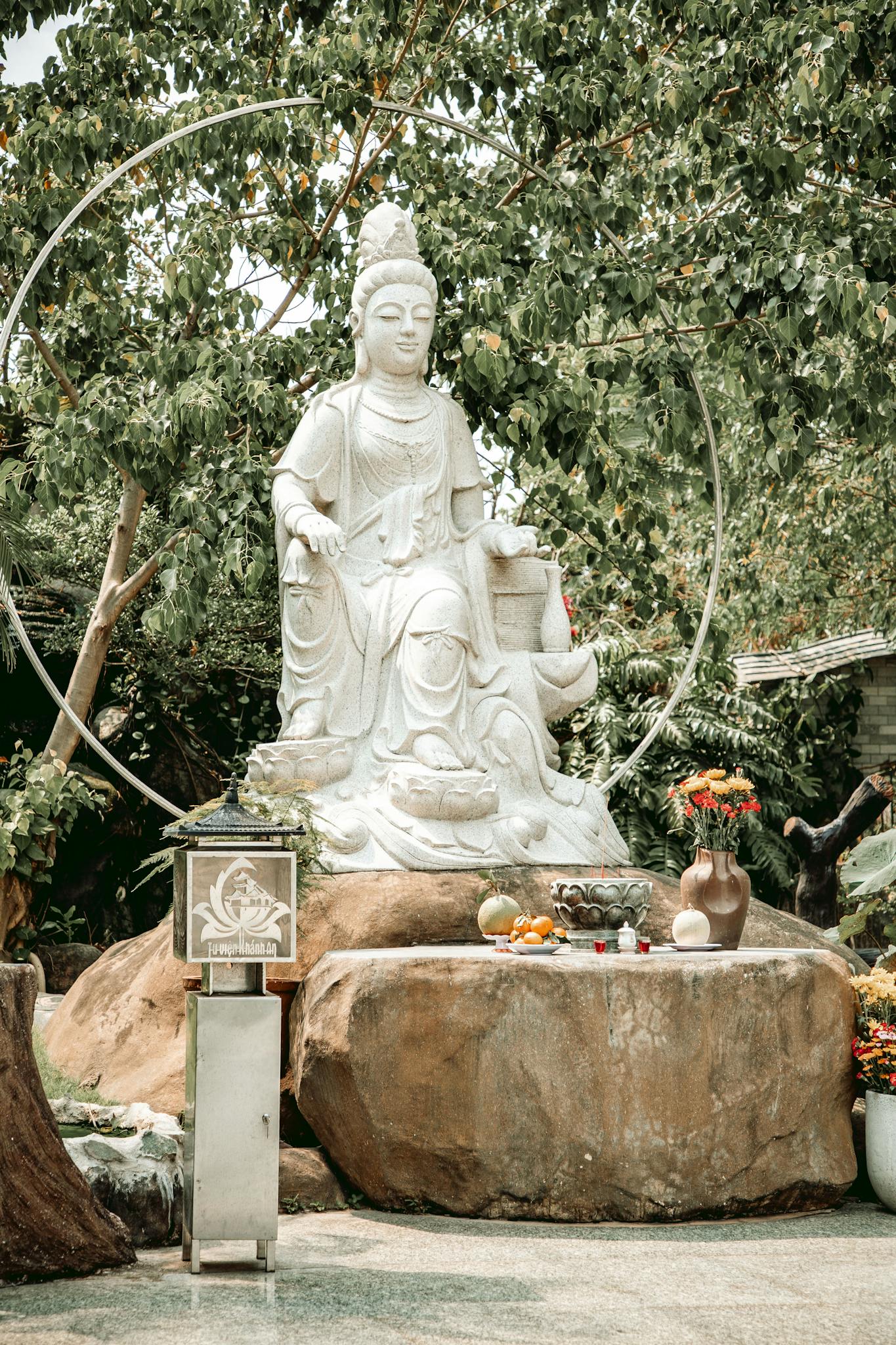 Serene Buddha statue surrounded by greenery, perfect for meditation or relaxation themes.